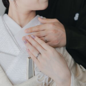 白無垢の襟元に重ねた新郎新婦の手元のアップ。指輪が光る和装スタジオフォトの定番カット